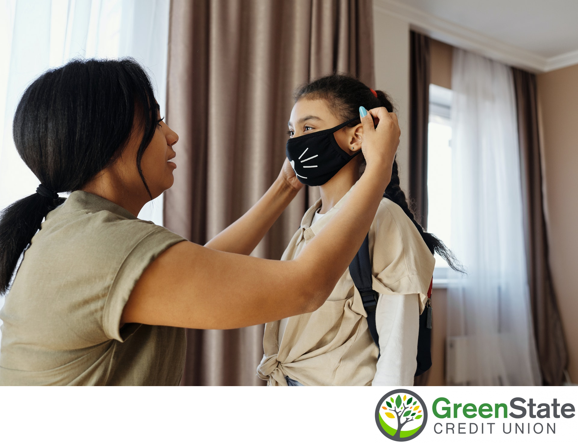 mother putting mask on daughter